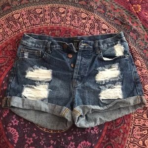 Distressed button up shorts.